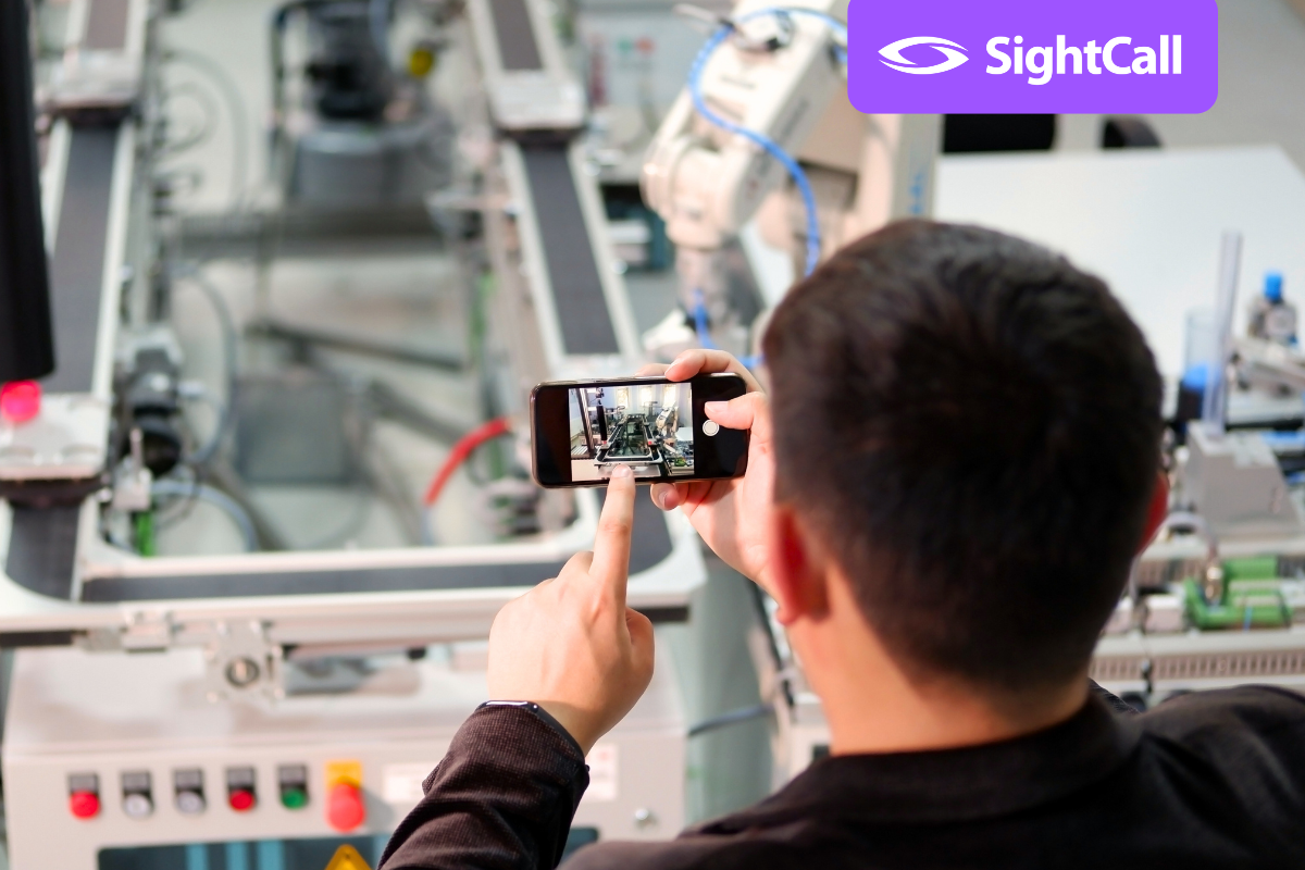 man using remote visual support on industrial machine